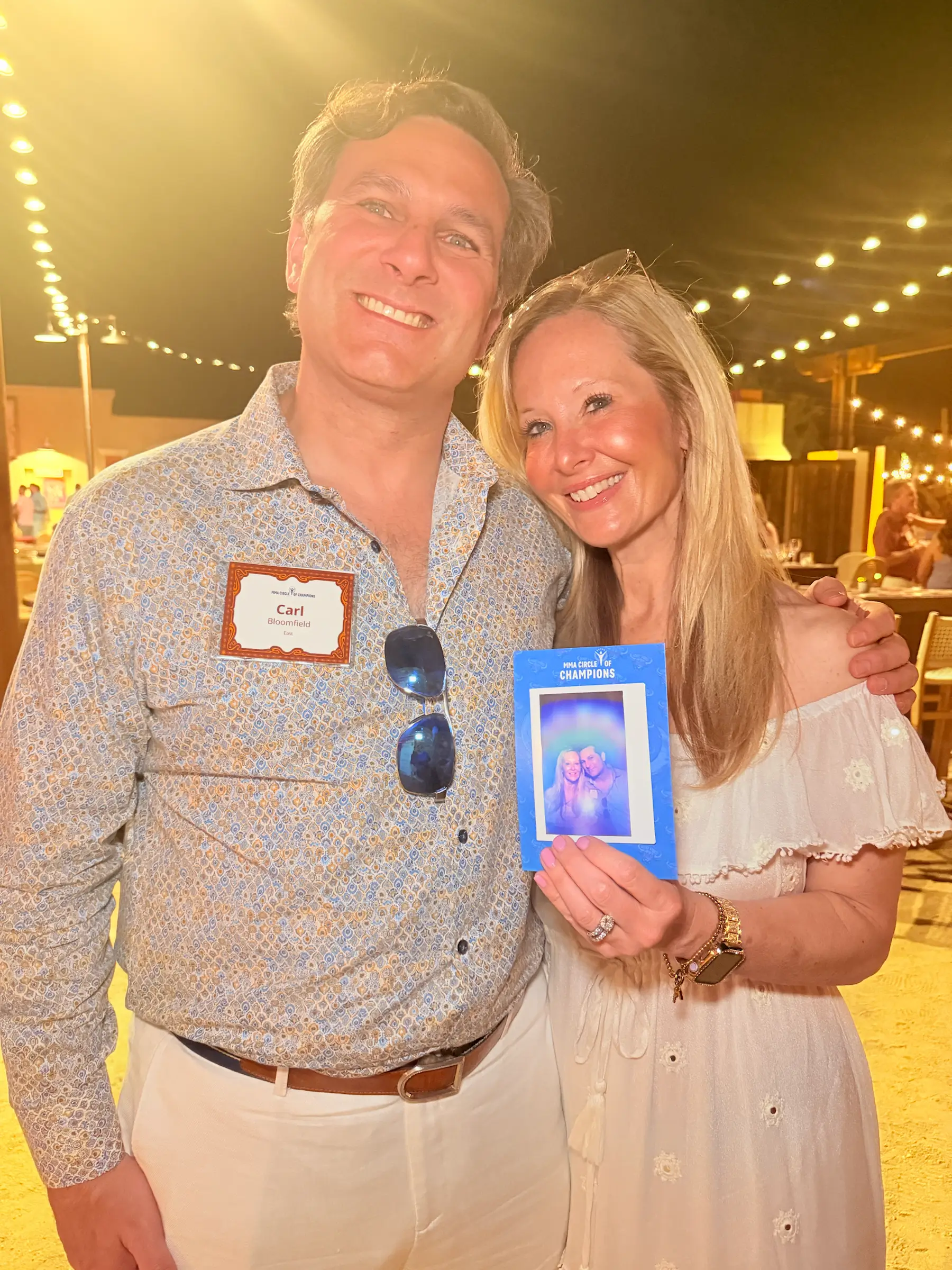 Event guests smiling while holding an aura photography keepsake