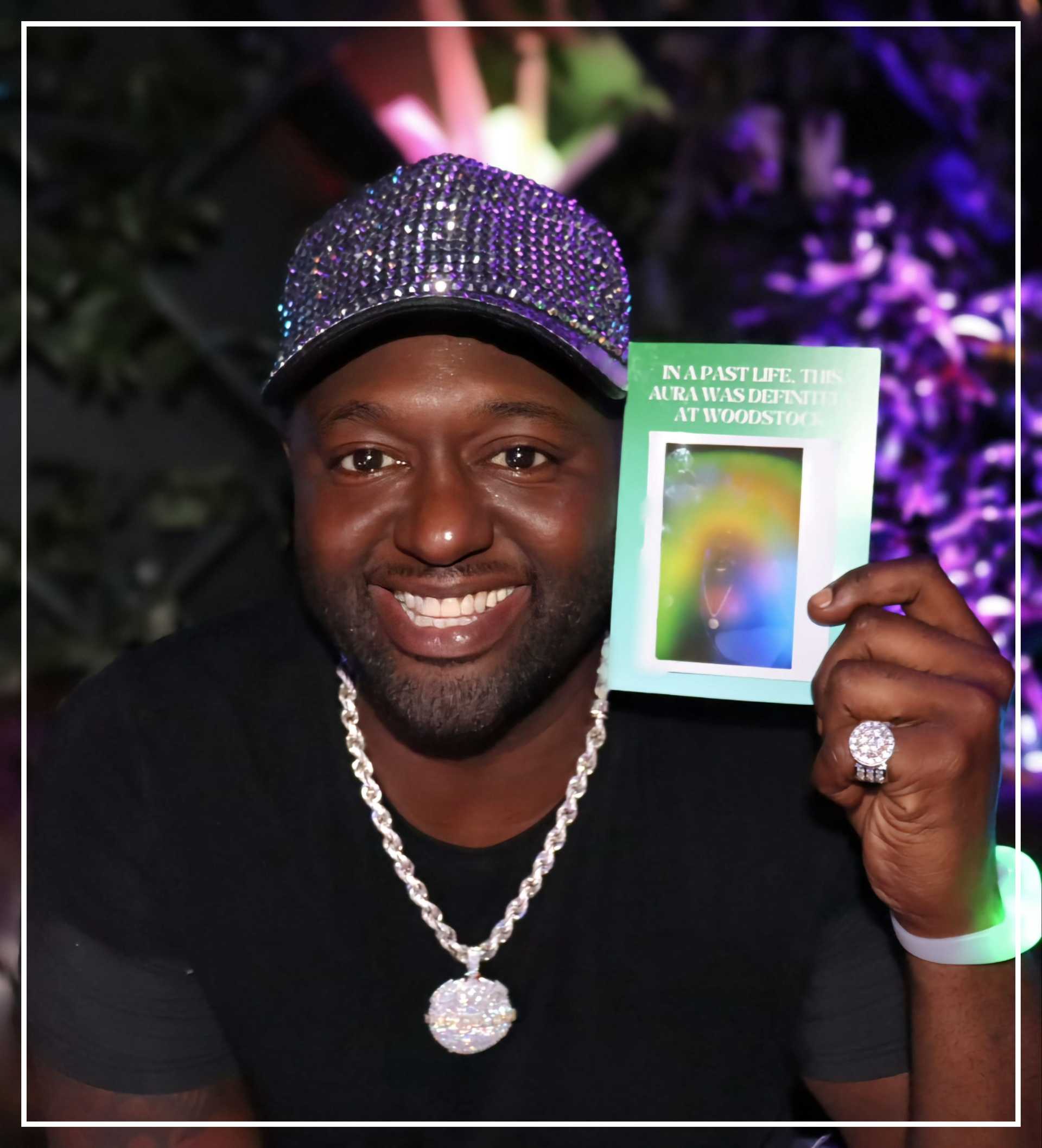 A man is holding an Aura Photo in the event